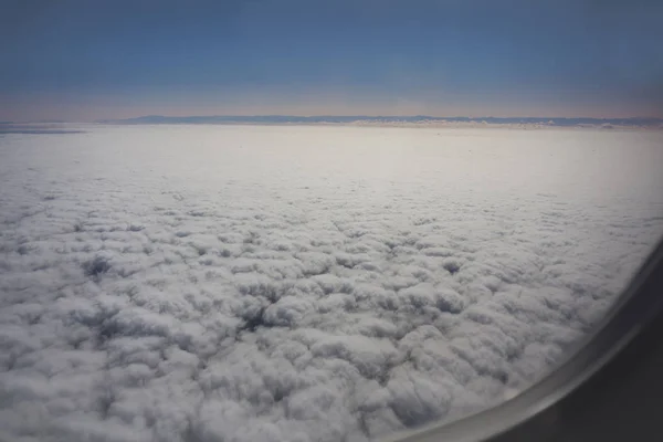 Ουρανό, σύννεφα και αεροπλάνο πτέρυγα μέσα από το παράθυρο — Φωτογραφία Αρχείου