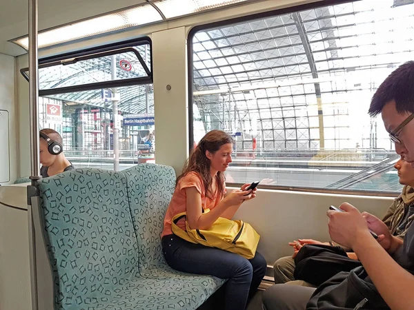 Young woman using mobile device on train — Stock Photo, Image