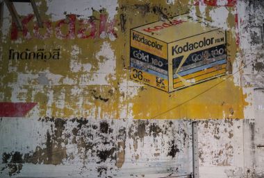 peeling painted sign of of old Kodacolor film sign on citty stre clipart