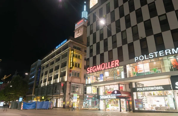 Stuttgart night street with large retail brands noen signage and — Stock Photo, Image