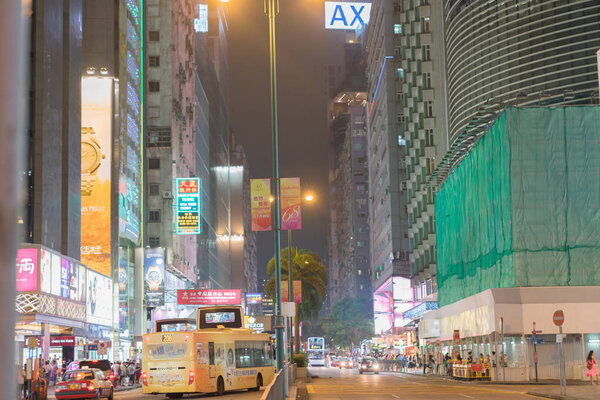 KOWLOON, HONG KONG - SEPTEMBER 19 2017; Typically Asian city street under night lights looking up Nathan Road in downtown business and retail district.
