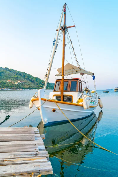 Classical style lines and styled boat moored to jetty Stock Picture