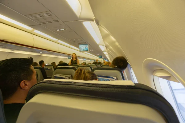 Seating and passengers inside passenger plane — Stock Photo, Image