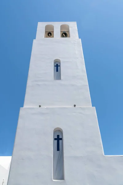 Tall white church bell tower.