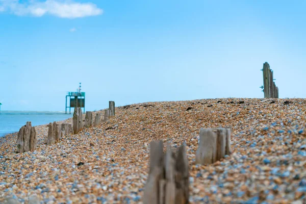 Remains Old destroyed pier on stony beach along Rother River — 스톡 사진