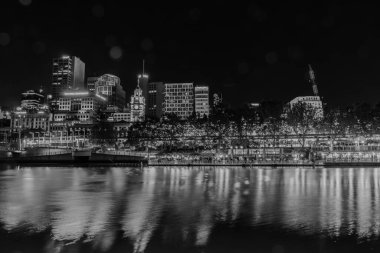 Melbourne Avustralya - 9 Mart 2020; Gece, binalar, ışıklar ve kurumsal markalar Yarra Nehri boyunca tek renkli işaretler.