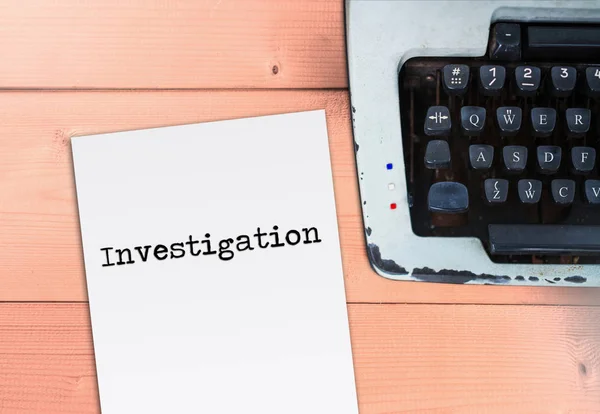 Investigation on paper with typewriter on wood table — Stock Photo, Image