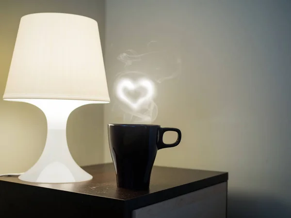Heart smoke on coffee mug with lamp