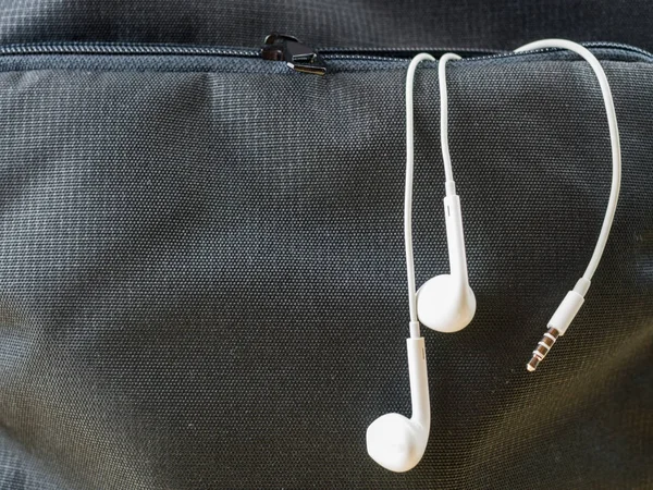 Earphone, in ear headphone in front pocket, music and lifestyle