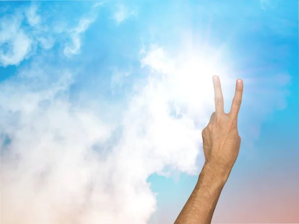 Two fingers and pastel sky background