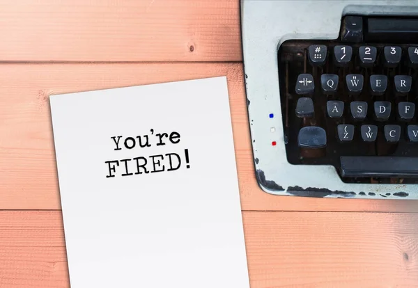 You're fired on paper with typewriter, job crisis and office sit — Stock Photo, Image