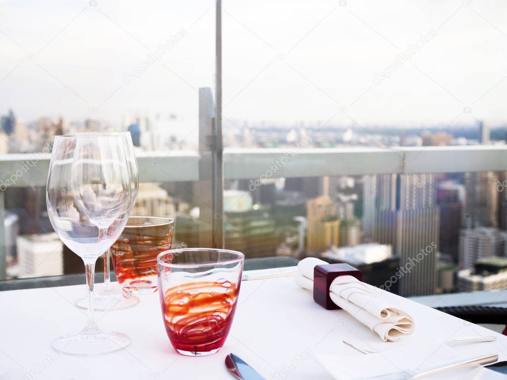 Table setting at rooftop bar, skyscraper restaurant view