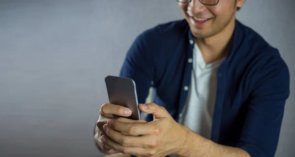 Hombres Sonriendo Usando Teléfono Sobre Fondo Gris —  Fotos de Stock