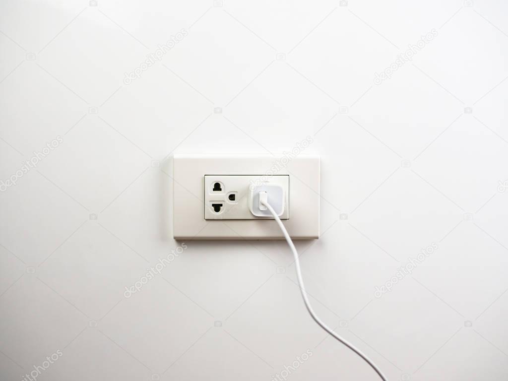 Phone plugged in on socket wall, charging