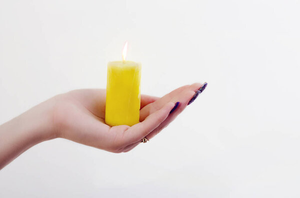 conflagrant candle is in a palm