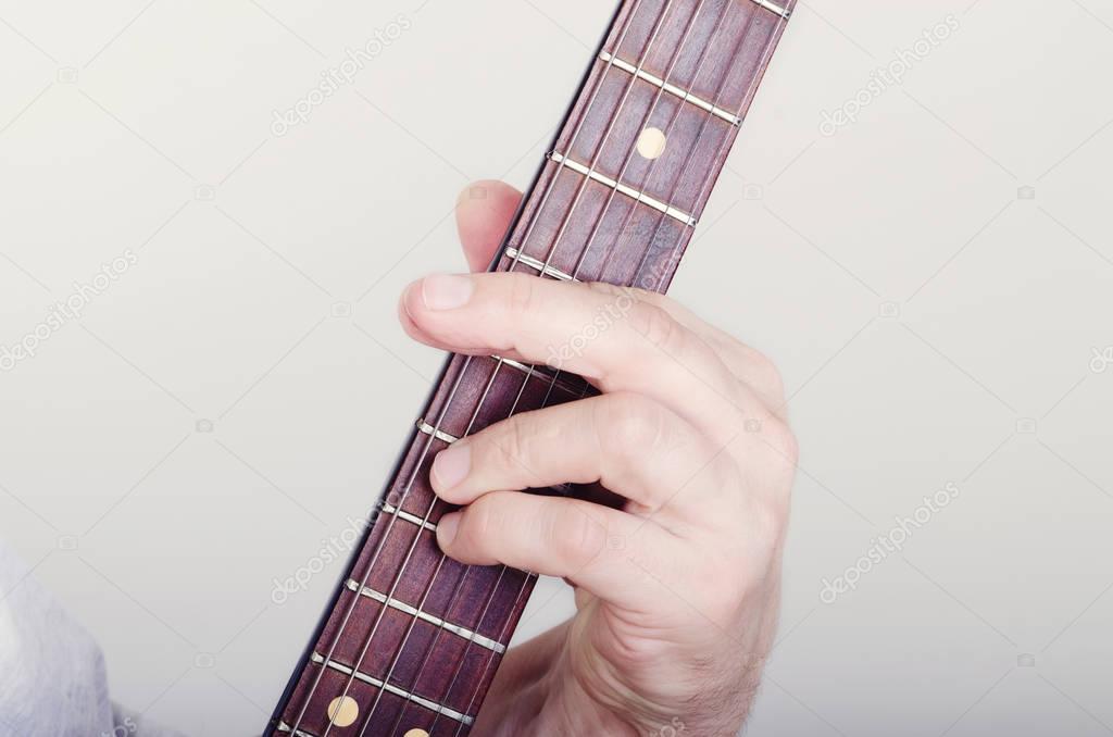hand on a guitar fingerboard