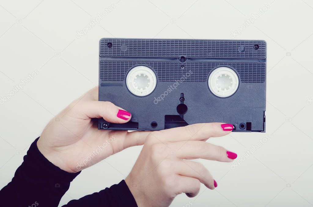 woman hands with a cassette