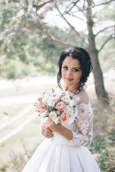 Beautiful bride outdoors in a forest. — Stock Photo, Image