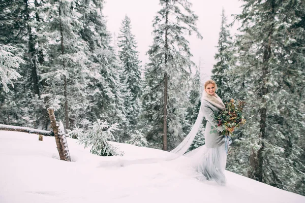 A jovem menina bonita espera por seu amante no meio das montanhas cobertas de neve — Fotografia de Stock