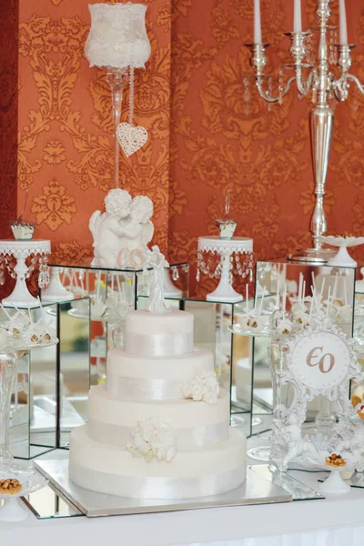 White floral wedding cake on restaurant interior background