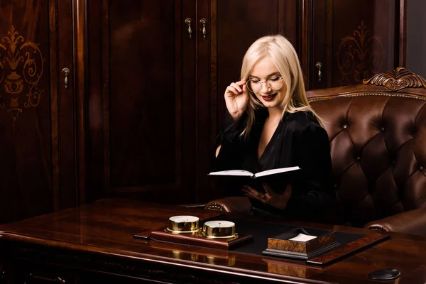 Çekici genç kadın güzel bir ofiste oturur