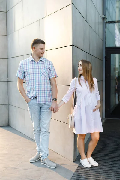 Young couple - man and woman expecting baby, spend time together on city street. — ストック写真
