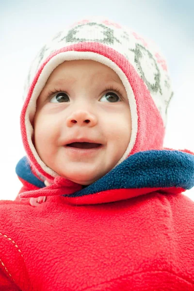 Child in hat and in red jacket close-up Stock Image
