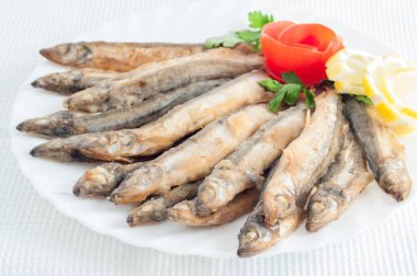 Çaça hamsi balıkla beyaz tabakta limon