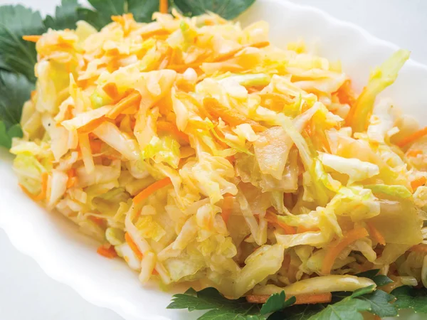 Sauerkraut salad with cabbage on a white plate — Stock Photo, Image