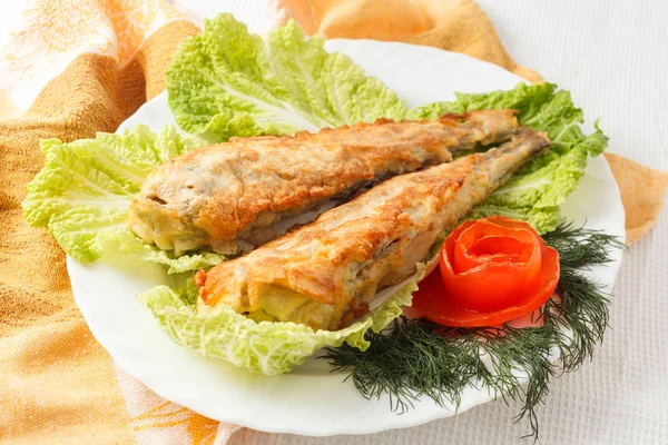 Fish in batter with greens on a white plate — Stock Photo, Image