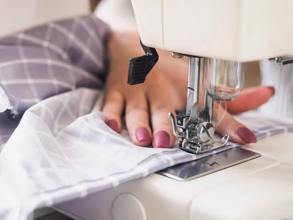 Girl working on sewing machine with textile napkins