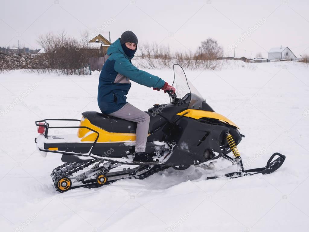 Man in the snowmobile. Winter snow field