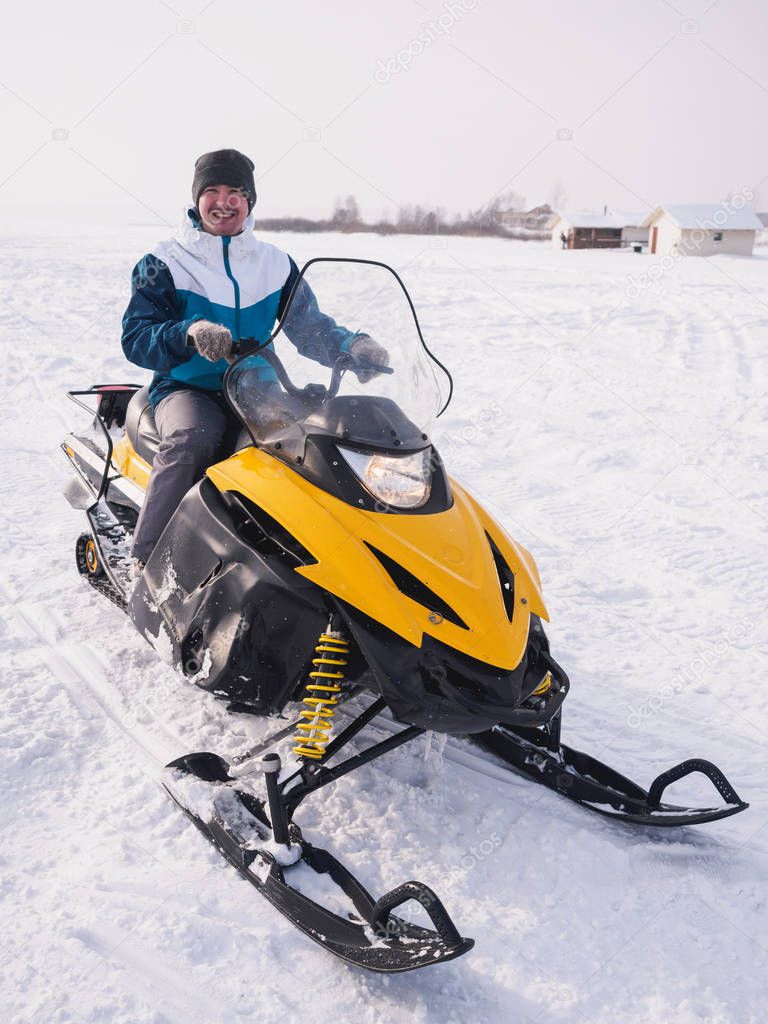 Man in the snowmobile. Winter snow field