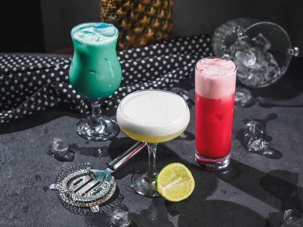 Color alcohol cocktails in bar. Black background