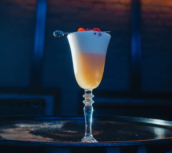 Yellow orange cocktail with cherry skewer on the barrel — 스톡 사진