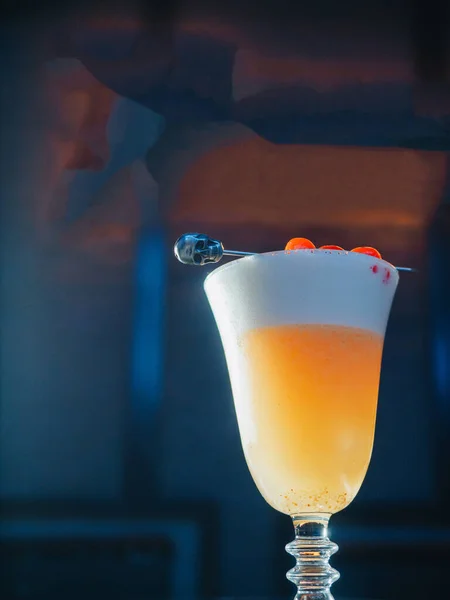 Yellow orange cocktail with cherry skewer on the barrel — 스톡 사진