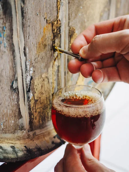 Glass with dark beer with wooden barrel — ストック写真