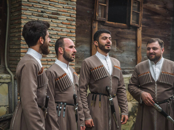 Tbilisi, Georgia - May 5, 2019: Georgian singers in national costumes in ethnographic museum