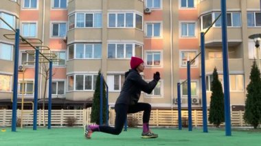 Şehir sokaklarında şınav çeken formda bir kız. Fitness kadını. Şınav, hamle, geğirme. Fonksiyonel yoğun eğitim