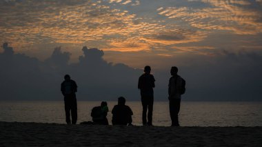 Sunrise plajda siluet insanlara 