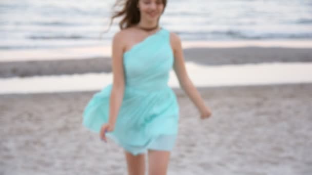 Happy playful woman runningto the camera, stop, smile and run away at the beach — Stock Video