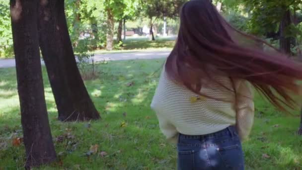 Woman with very long hair whirls and turns around in slow motion — Stock video