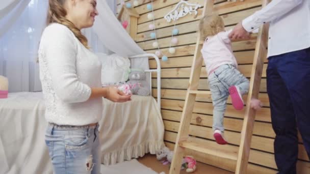 Vader helpt zijn meisje van de baby te klauteren op de ladder — Stockvideo