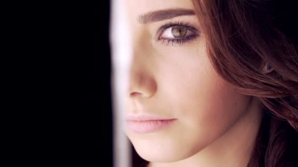 Beautiful Brunette Girl over Black Background. light and darkness — Stock Video