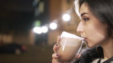 Genç esmer kadın portresi ile büyük bir fincan sıcak bir içecek kadar soğuk gün boyunca kapatın.