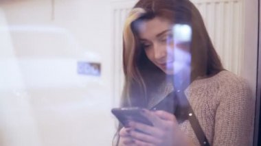 pencereden onun smartphone kullanarak yansımaları ile görüntülendi kadın kastamonuda ve gülümseyen