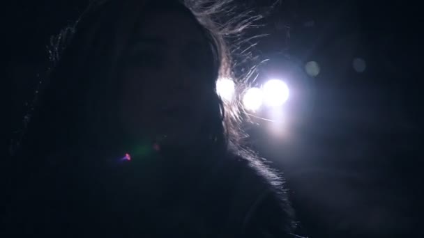 Porträtt av en ung brunett flicka i gatan natt staden. Trafikljus på backstage. — Stockvideo