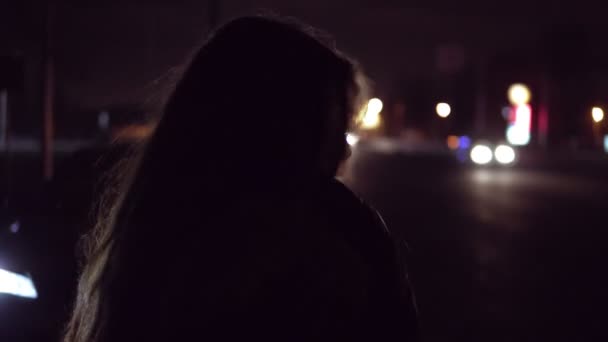 Πορτρέτο της η νεαρή μελαχρινή κοπέλα στην πόλη δρόμο νύχτα. Φανάρια στα παρασκήνια. — Αρχείο Βίντεο