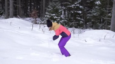 Ormanın içinde kar üzerinde kartopu Savaşı oyun bobble şapkalı mutlu genç kadın