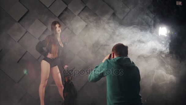 Backstage of photo session of young woman in lingerie with doberman in studio — Stock Video